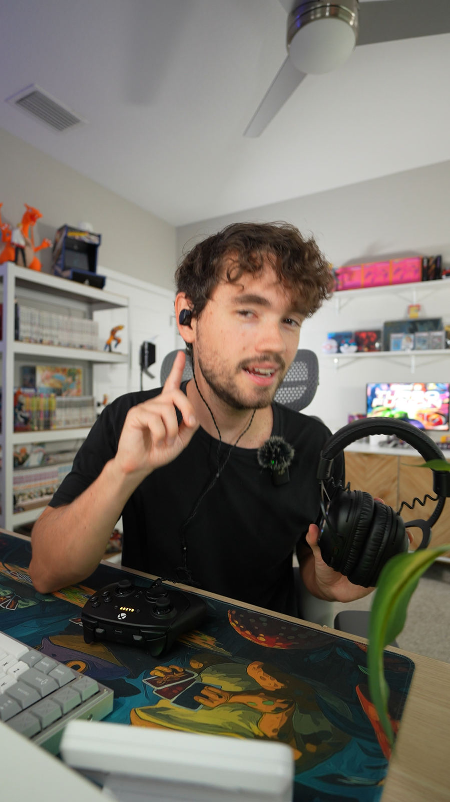 Marc Houston at his desk, wearing in-ear monitors and holding a gaming headset